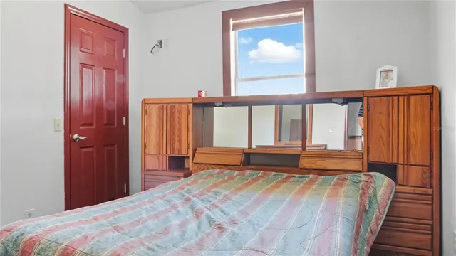 a bedroom with a bed and a window