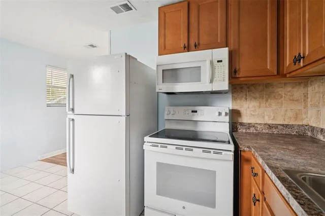 a kitchen with a stove top oven and cabinets