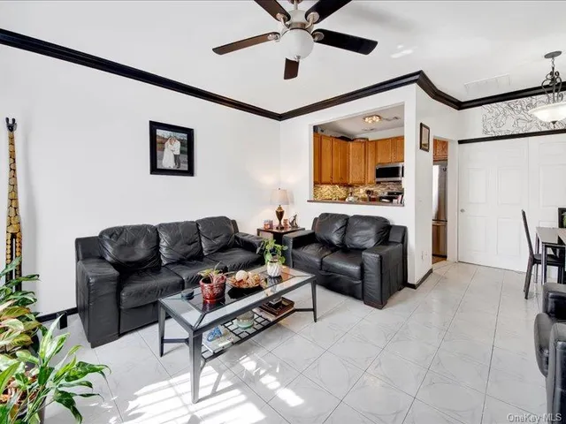 a living room with furniture and a ceiling fan