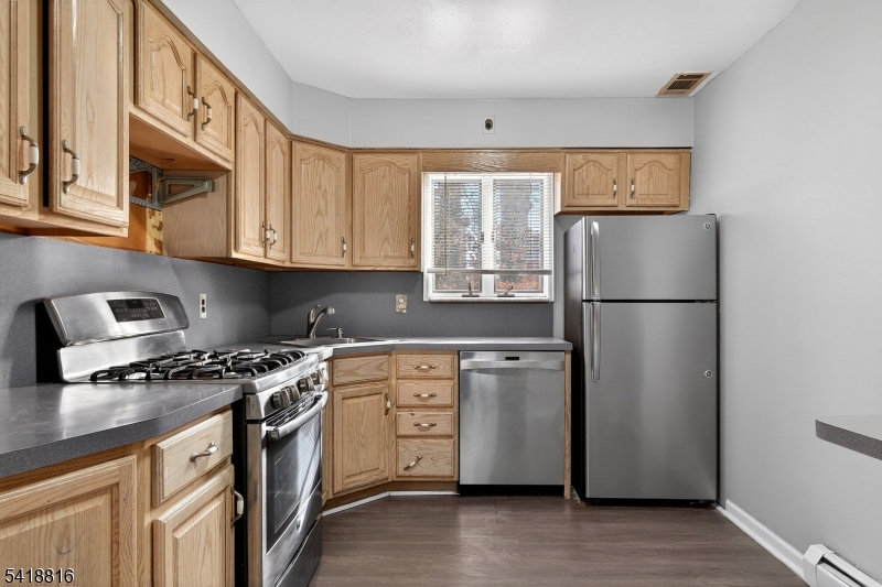 569 Scotland Road Union, NJ 07083 - Photo 13 of 23 a kitchen with stainless steel appliances granite countertop a refrigerator sink and stove