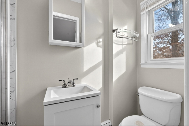 569 Scotland Road Union, NJ 07083 - Photo 16 of 23 a bathroom with a toilet sink and mirror