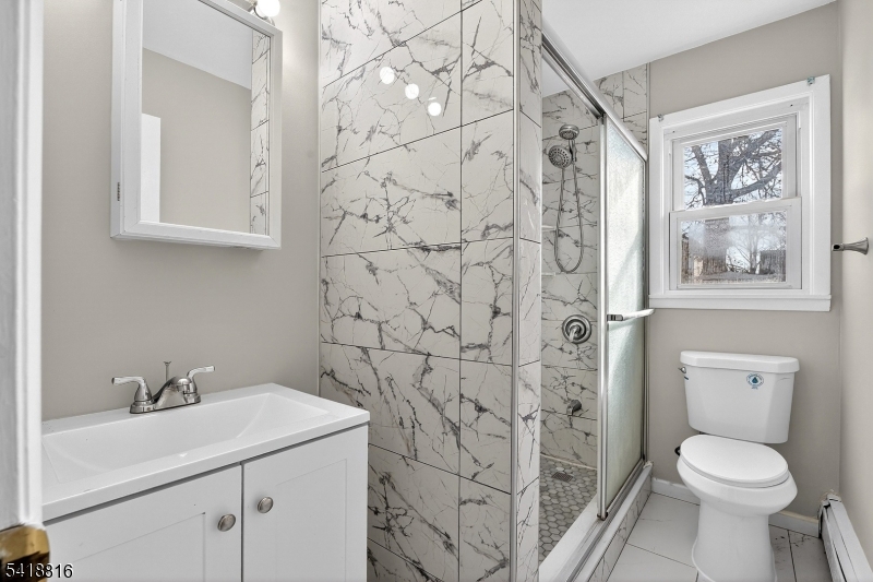 569 Scotland Road Union, NJ 07083 - Photo 19 of 23 a bathroom with a sink toilet and vanity