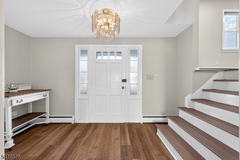 569 Scotland Road Union, NJ 07083 - Photo 8 of 23 a view of a livingroom with wooden floor and a kitchen