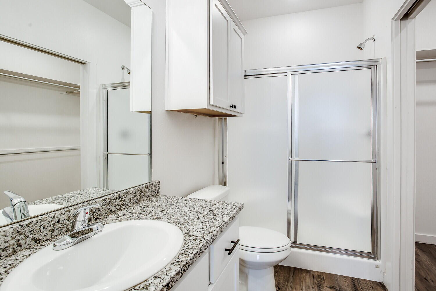 2535 138th Street Lubbock, TX 79423 - Photo 12 of 15 a bathroom with a granite countertop sink toilet and shower