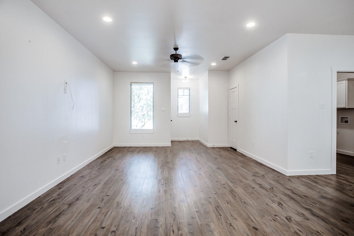 2535 138th Street Lubbock, TX 79423 - Photo 4 of 15 an empty room with wooden floor and windows