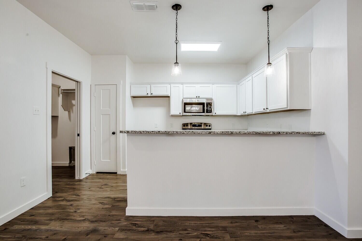 2535 138th Street Lubbock, TX 79423 - Photo 7 of 15 a view of kitchen with stainless steel appliances granite countertop cabinets and wooden floor