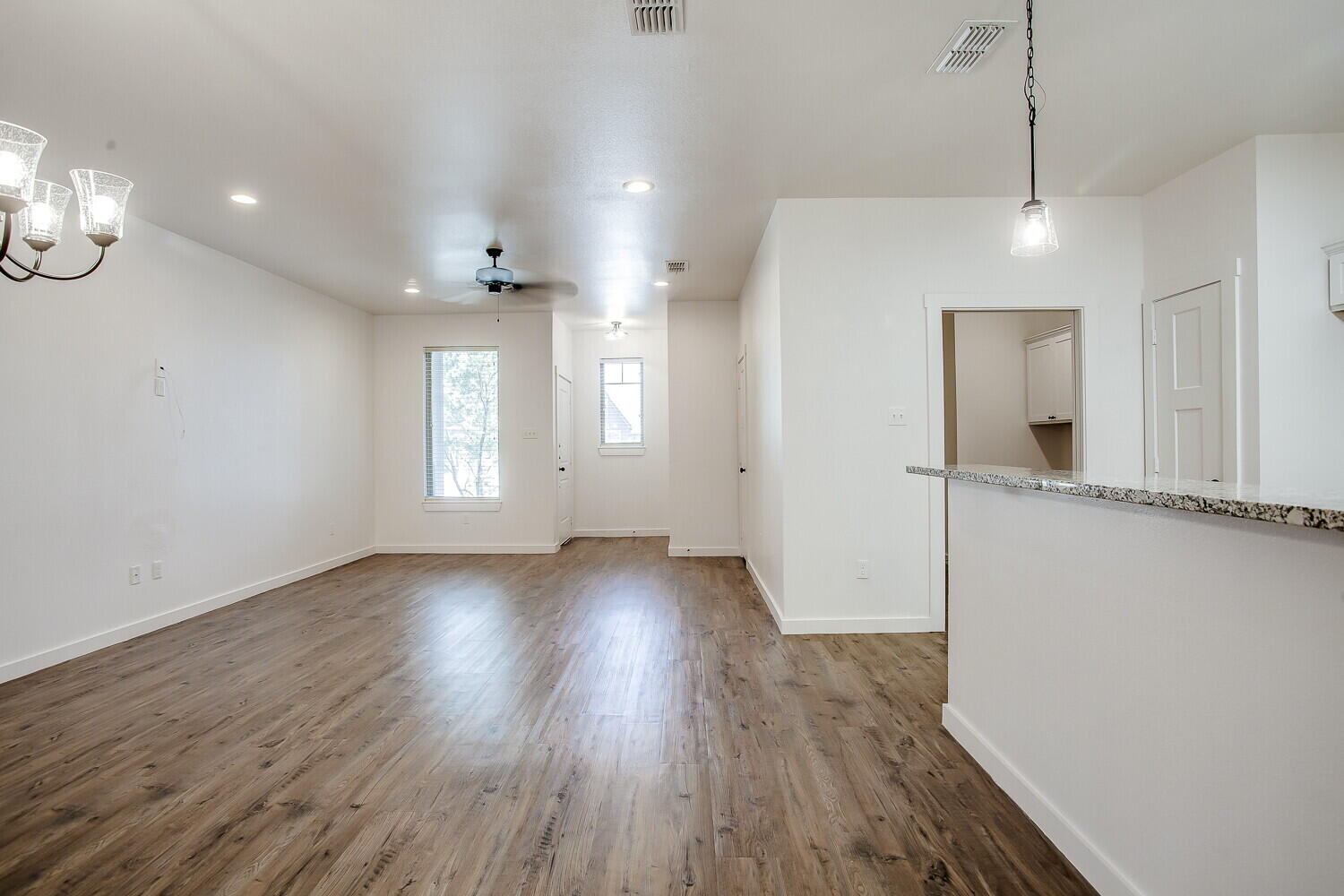 2535 138th Street Lubbock, TX 79423 - Photo 8 of 15 an empty room with wooden floor and windows