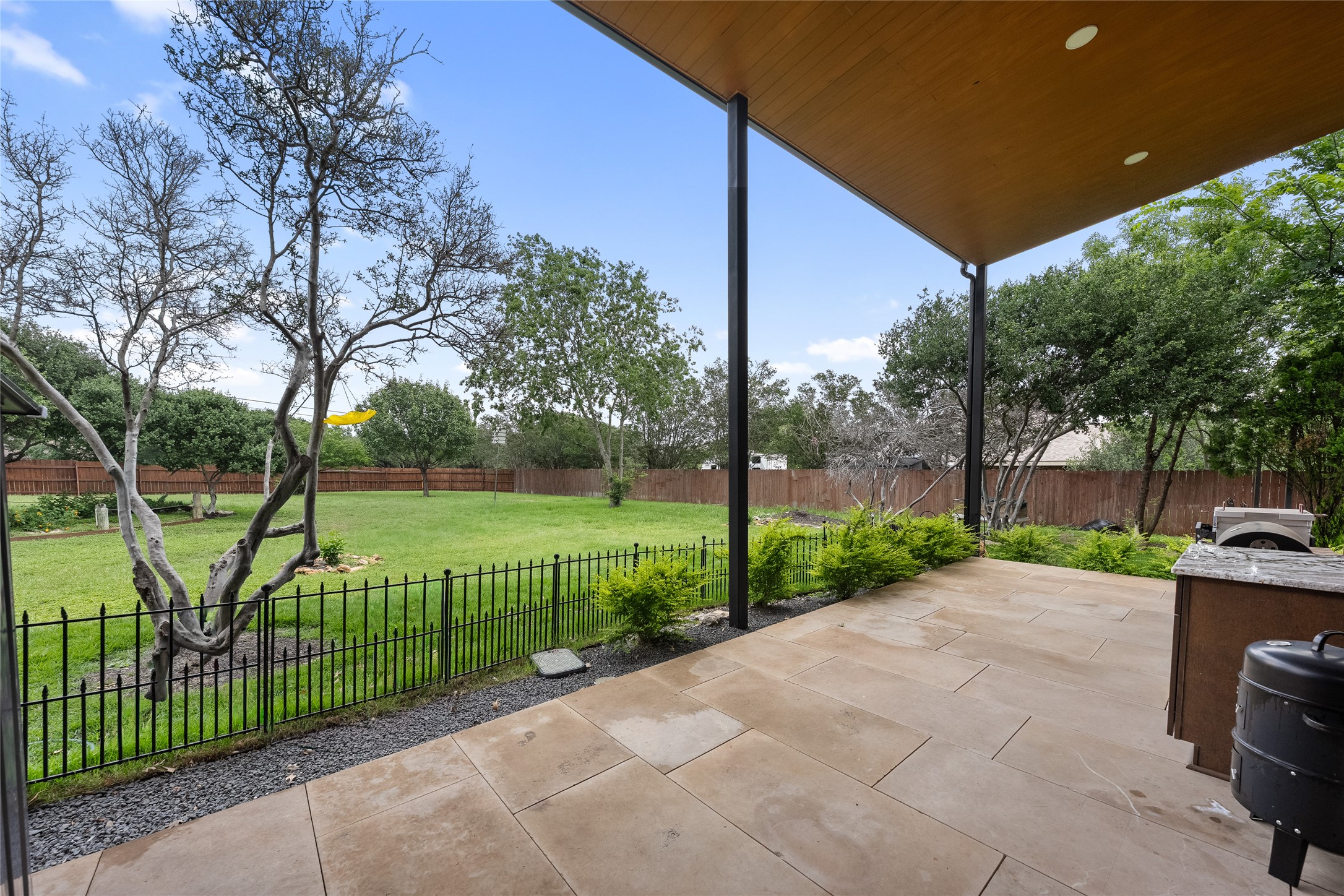 301 Oak Ridge Road Georgetown, TX 78628 - Photo 22 of 34 Covered patio featuring large format tile flooring and a built-in outdoor cooking area
