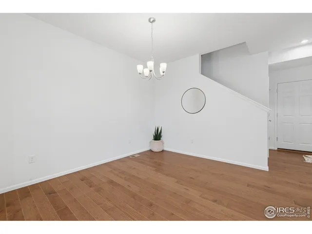 a bedroom with a bed a table and chair