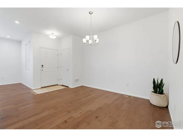 a front view of a house with a yard and potted plants
