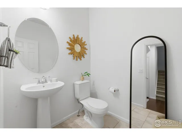 an aerial view of ocean and residential houses with outdoor space