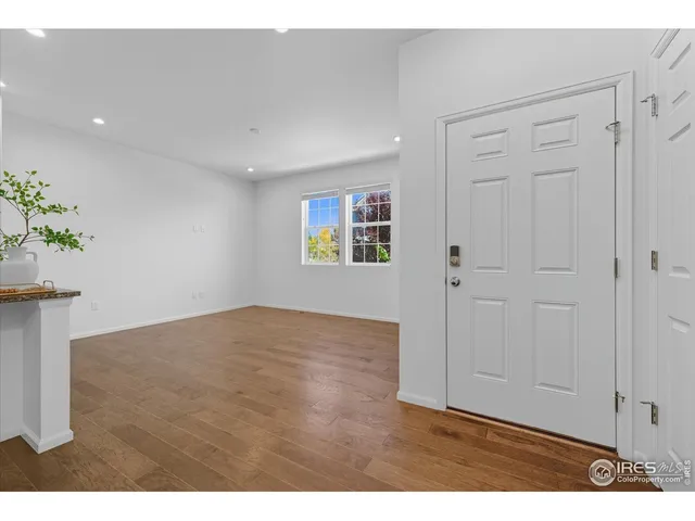 a view of a room with wooden floor and potted plant