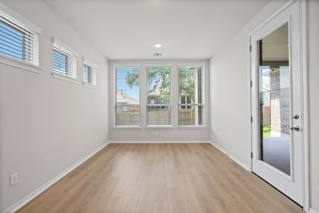 wooden floor in an empty room with a window