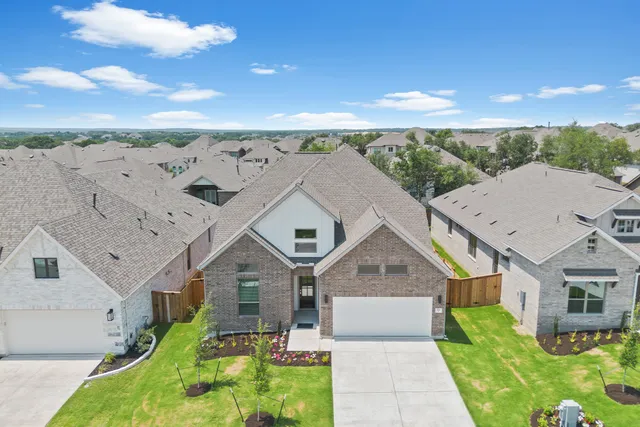 a aerial view of a house with a yard