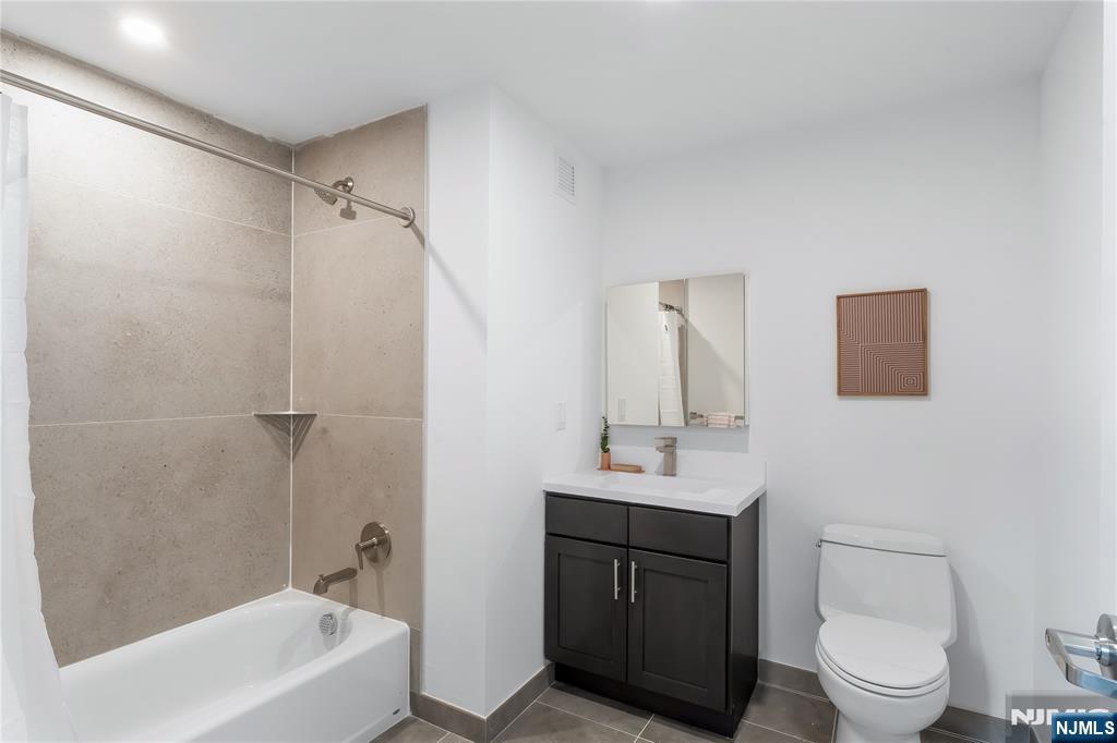 10 Commerce Court, Unit 3G Newark, NJ 07102 - Photo 11 of 11 a bathroom with a sink toilet vanity and shower