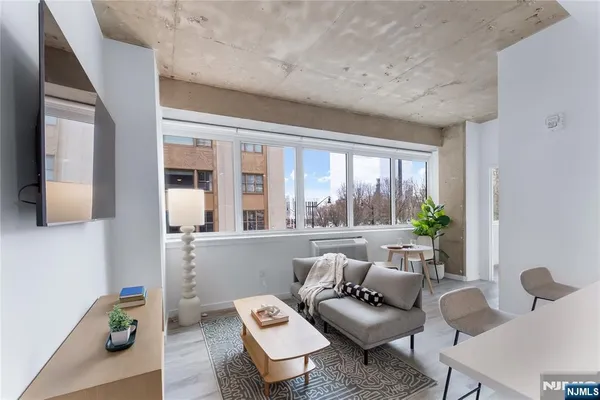 a living room with furniture and a large window