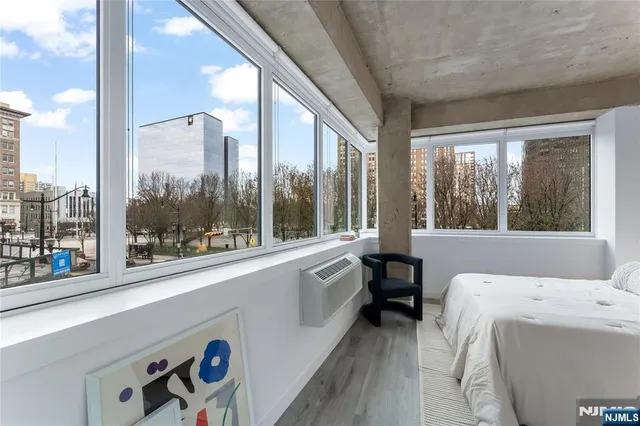 a living room with a large window and furniture