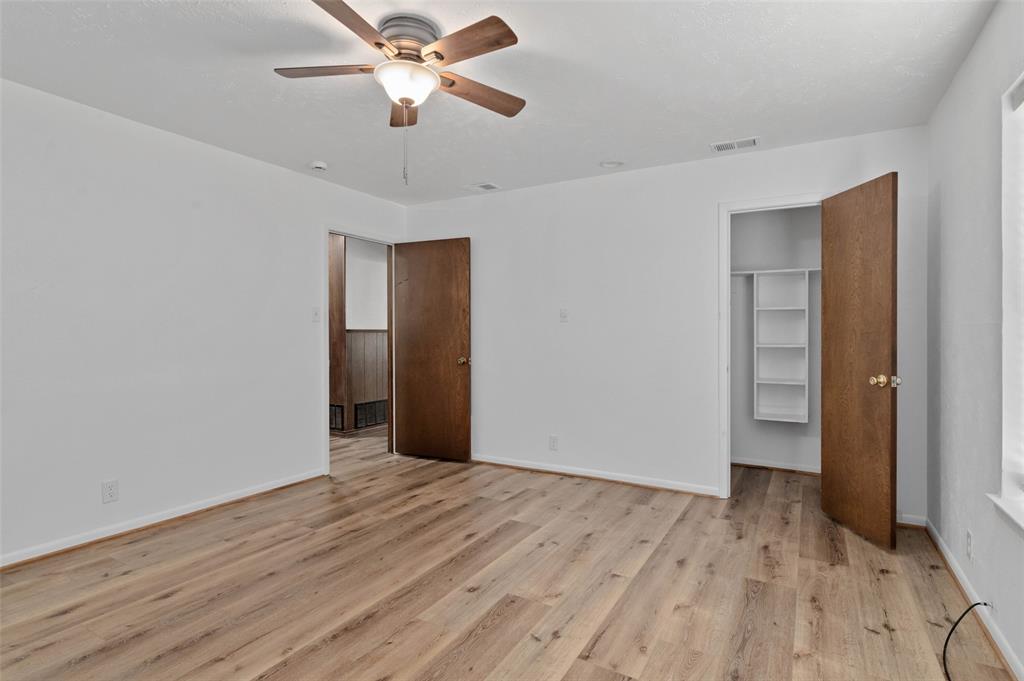 301 East 6th Street Krum, TX 76249 - Photo 18 of 29 Interior space featuring wood-finish flooring, white walls, and a ceiling fan with integrated lighting