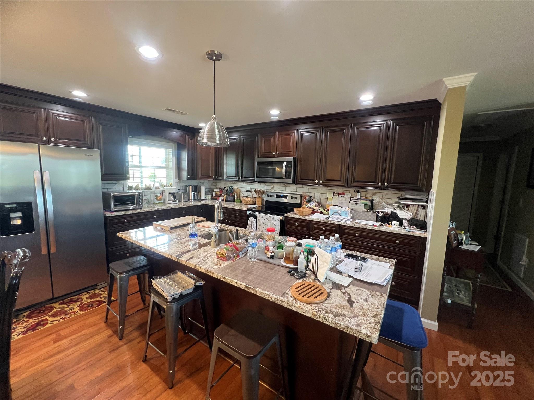 1301 Double Springs Church Road Shelby, NC 28150 - Photo 7 of 42 a kitchen with a dining table chairs refrigerator and microwave