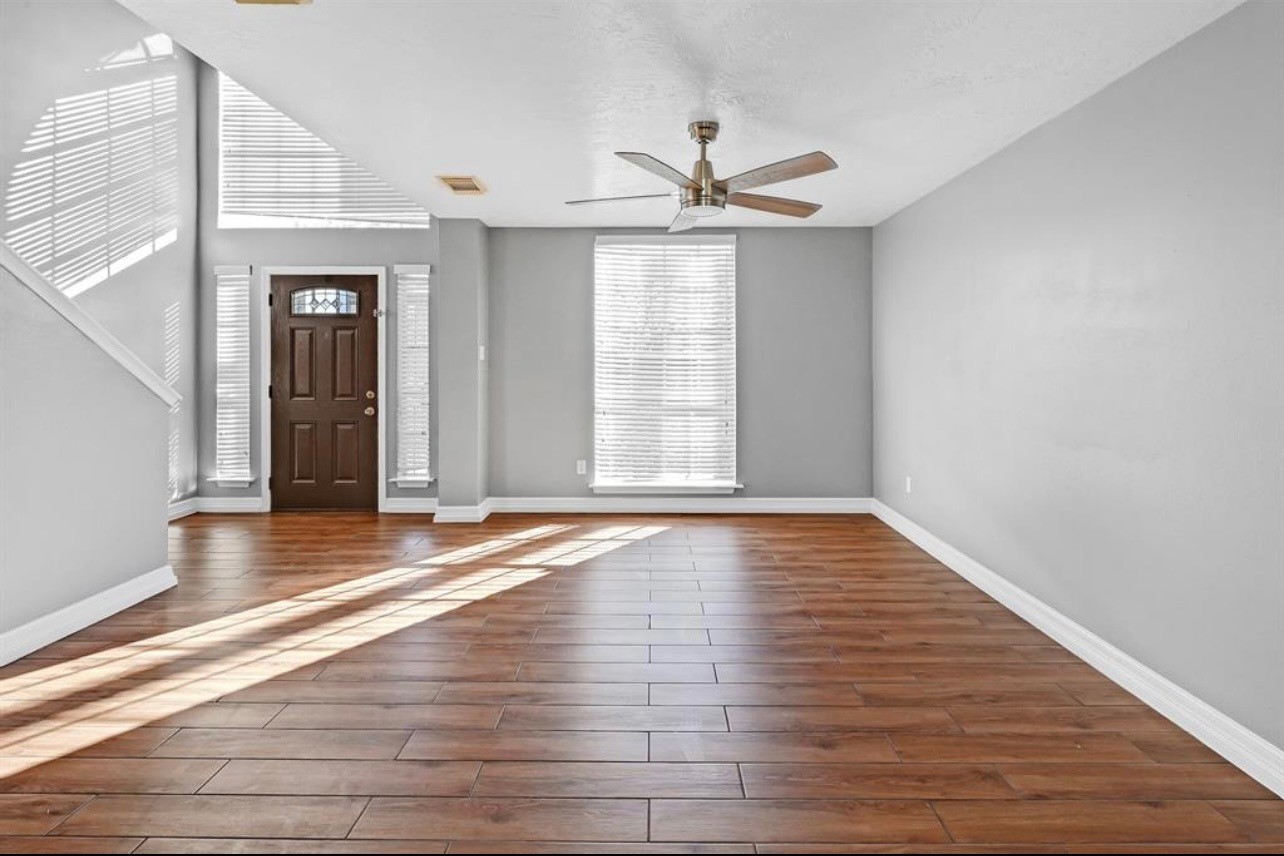 262 Normandy Street Houston, TX 77015 - Photo 3 of 12 a view of empty room with wooden floor and fan