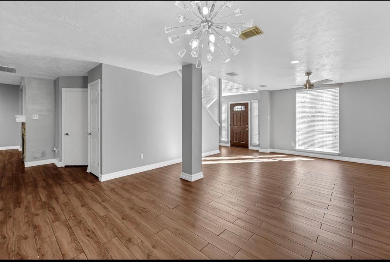 262 Normandy Street Houston, TX 77015 - Photo 4 of 12 wooden floor in an empty room with a window