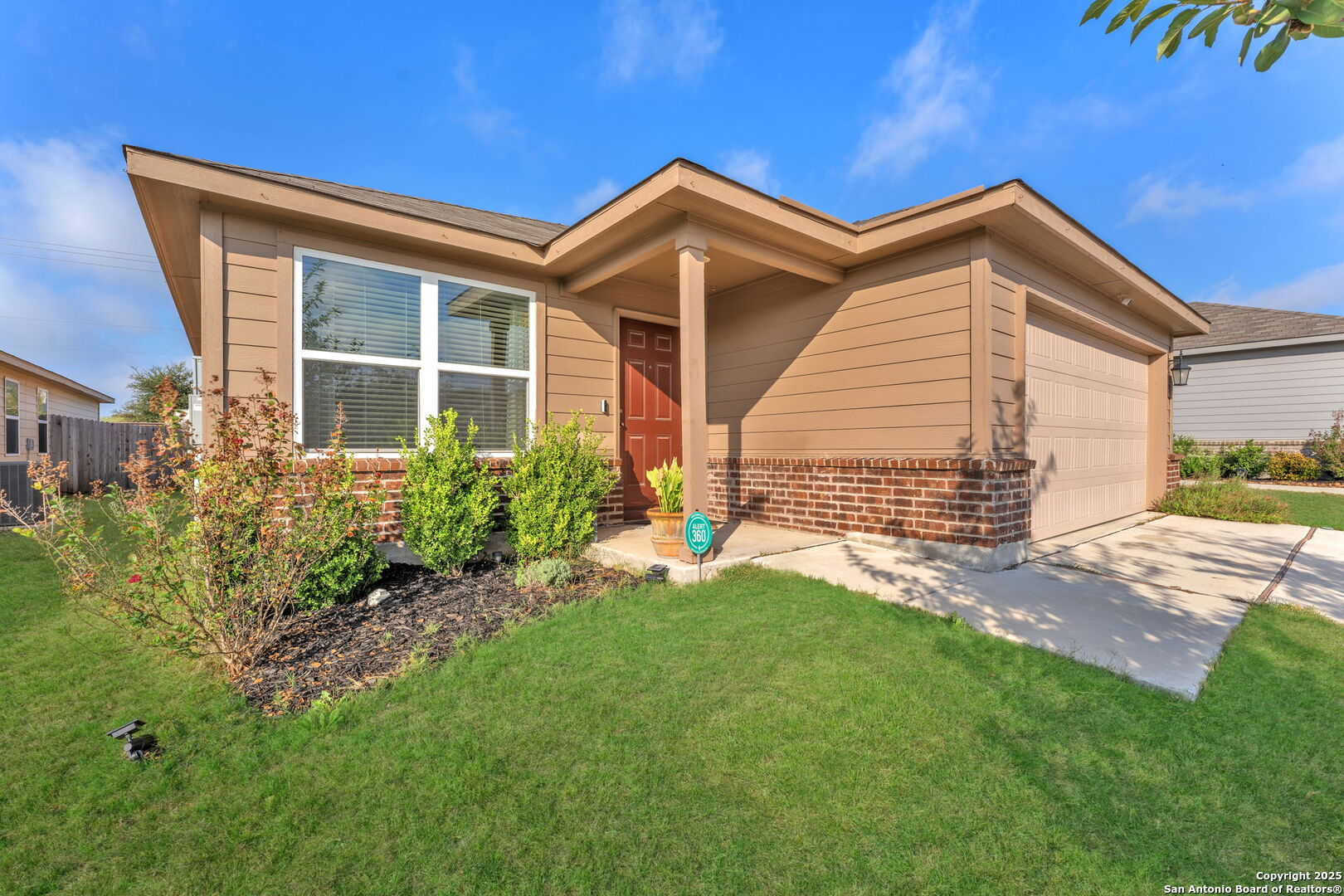 a view of a house with a small yard and plants