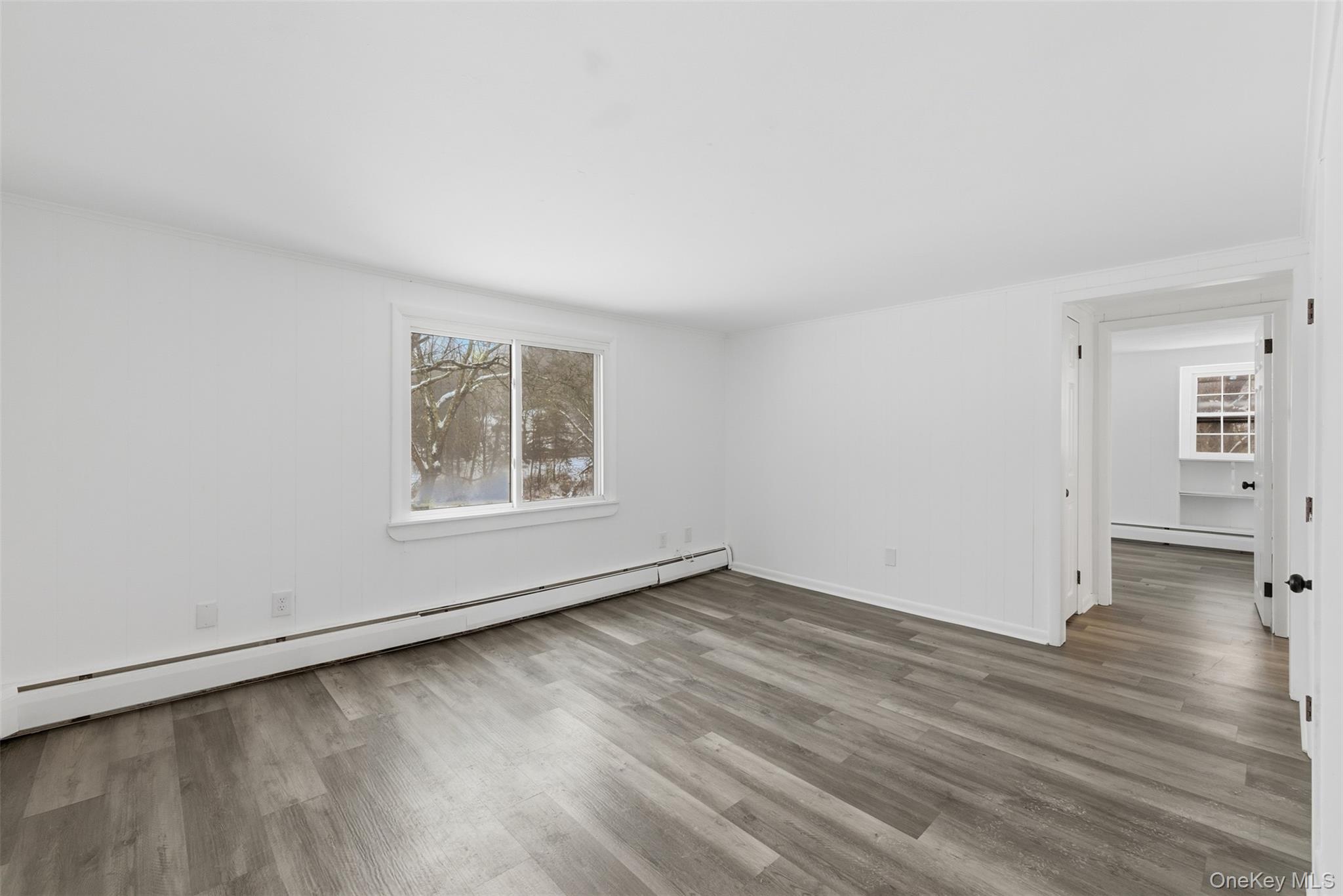 63 Parksville Road Pleasant Valley, NY 12569 - Photo 7 of 20 an empty room with wooden floor and windows