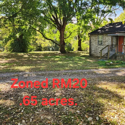a front view of house with yard and flowers