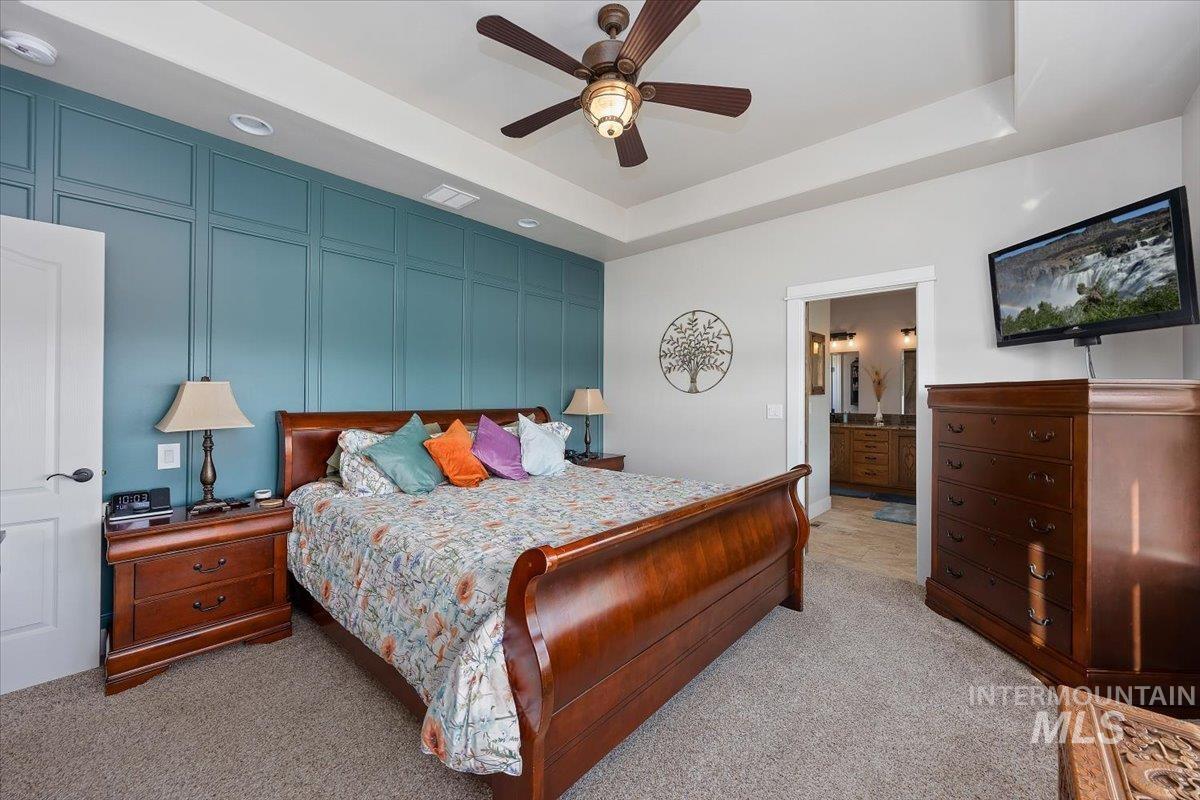 40 Bell Rapids Road Hagerman, ID 83332 - Photo 20 of 50 Bedroom with a decorative wall, light carpet, a ceiling fan, ensuite bath, and an accent wall