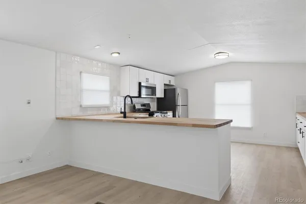 a kitchen with stainless steel appliances a sink and a microwave