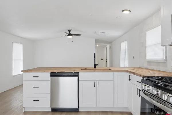 a kitchen with granite countertop a stove and a sink