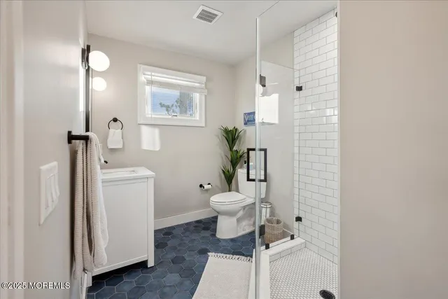a bathroom with a toilet a sink and garden