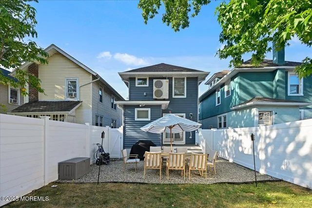 a front view of a house with swimming pool table and chairs