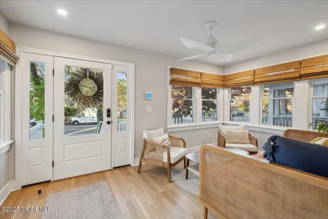 a living room with furniture and large windows
