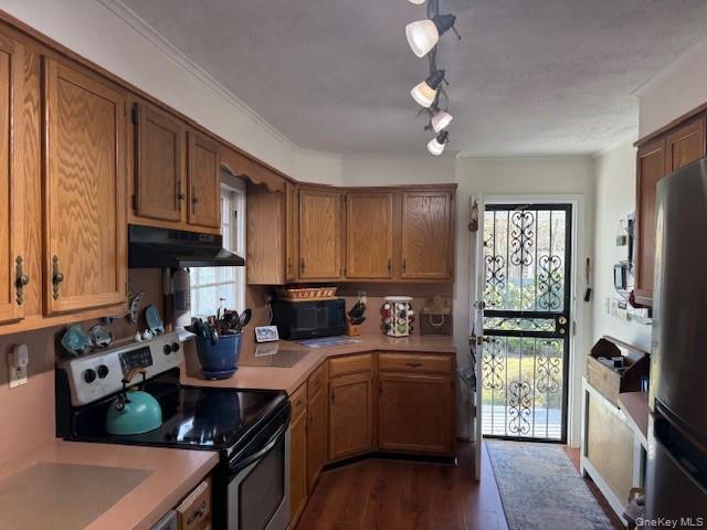 154 Cedar Road East Mastic Beach, NY 11951 - Photo 2 of 9 a kitchen with refrigerator a stove and wooden floor