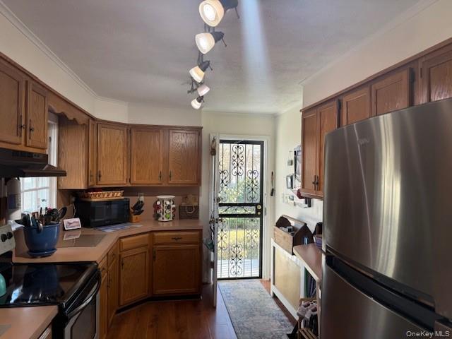 154 Cedar Road East Mastic Beach, NY 11951 - Photo 3 of 9 a kitchen with a refrigerator a sink and cabinets