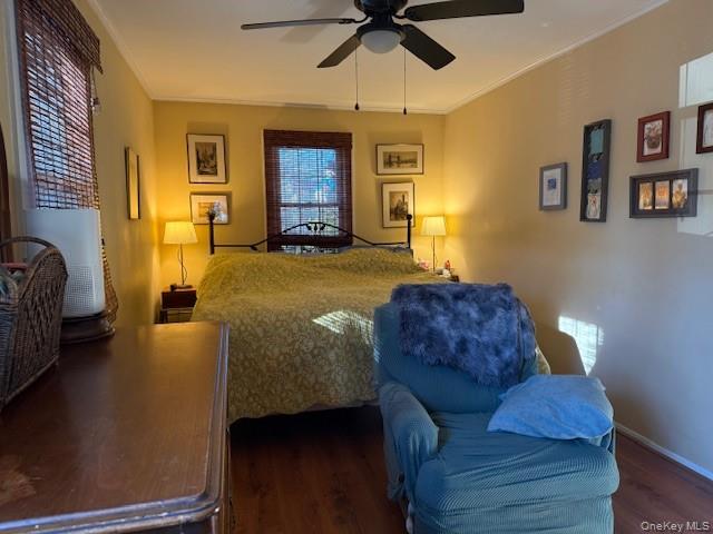 154 Cedar Road East Mastic Beach, NY 11951 - Photo 7 of 9 a bedroom with a bed couch and a ceiling fan