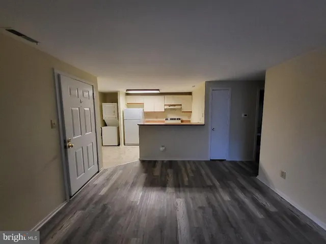 a view of a kitchen from a hallway