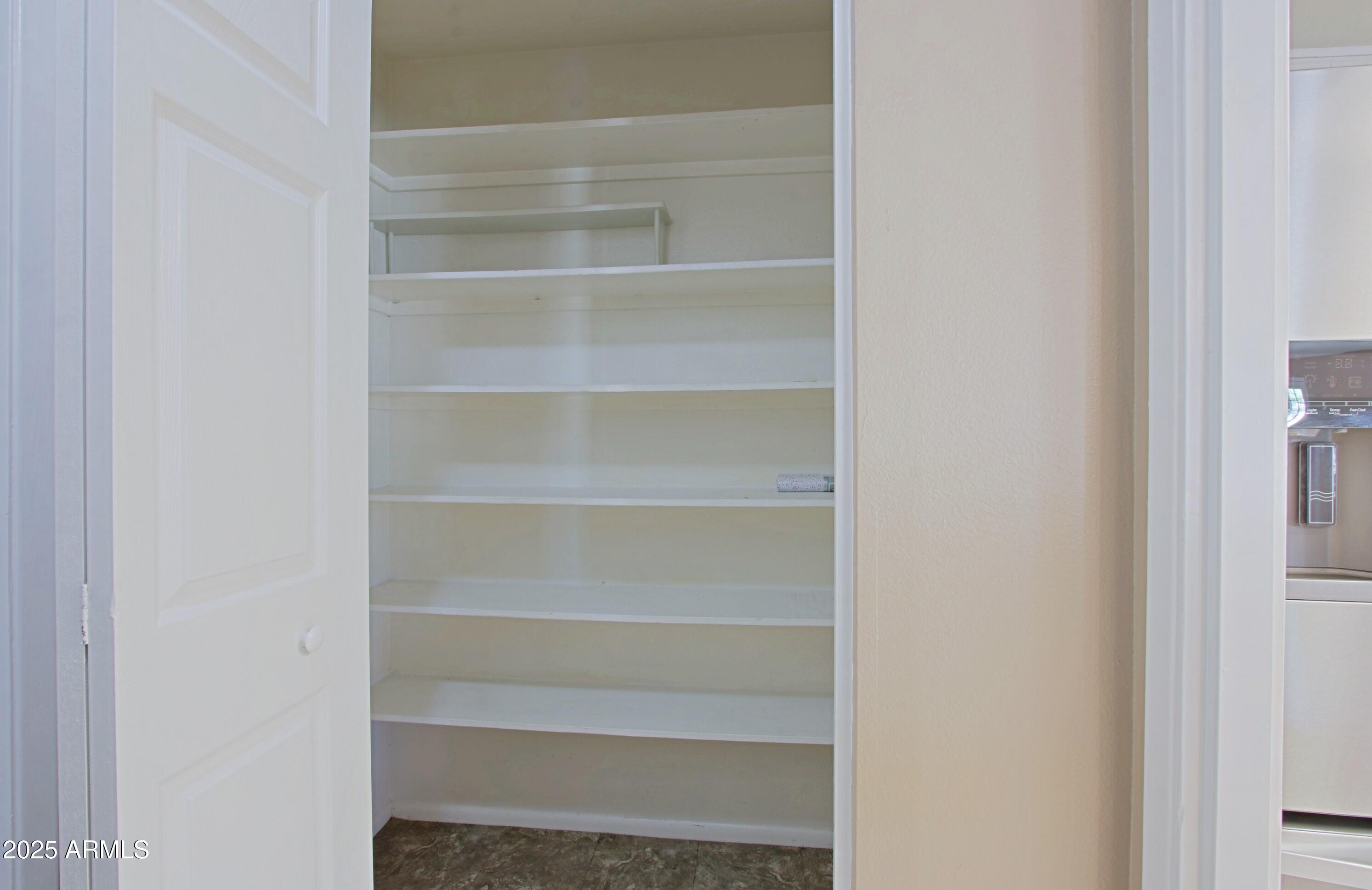 4526 West Altadena Avenue Glendale, AZ 85304 - Photo 11 of 38 a view of walk in closet with empty racks