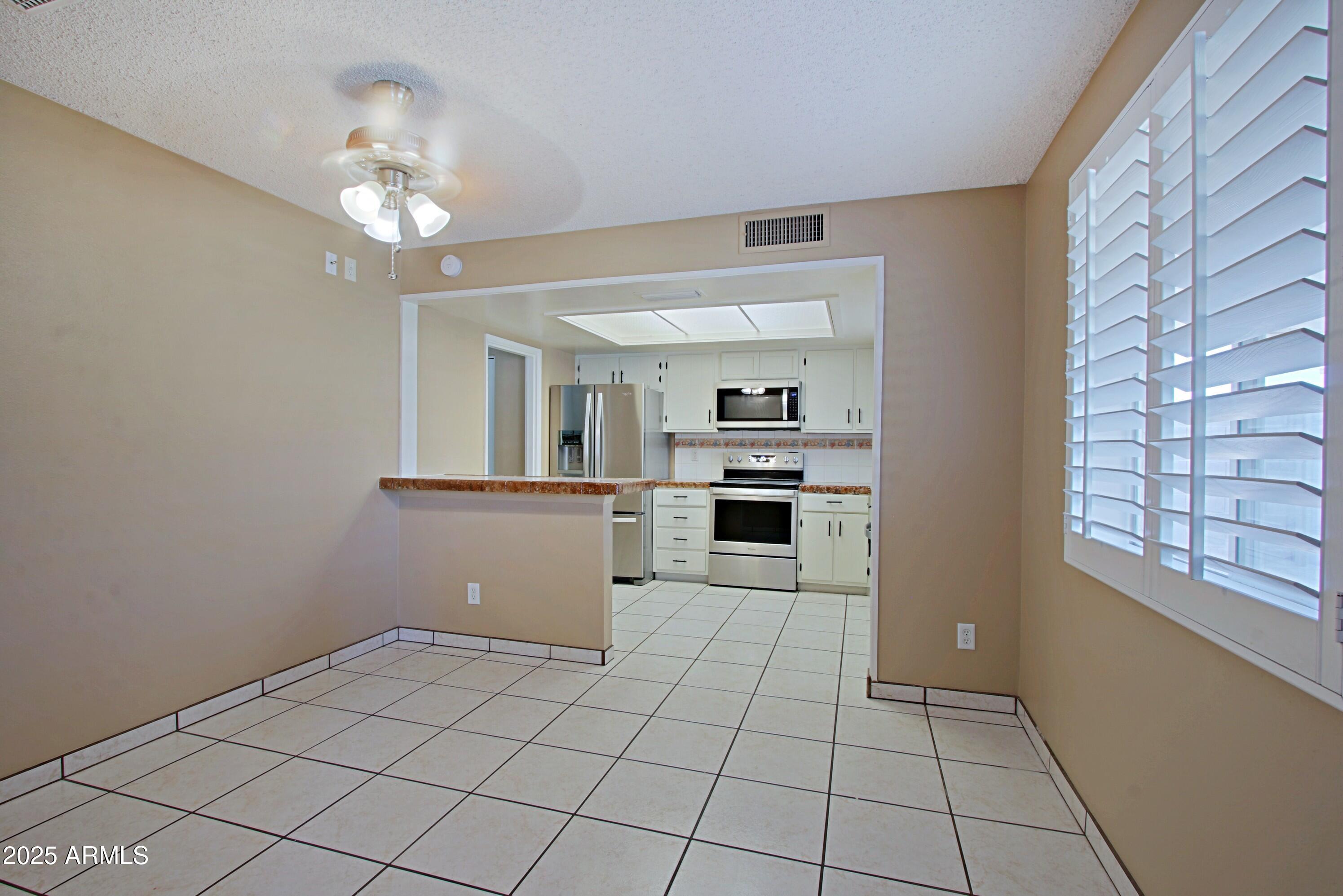 4526 West Altadena Avenue Glendale, AZ 85304 - Photo 12 of 38 a view of a kitchen with microwave and cabinets