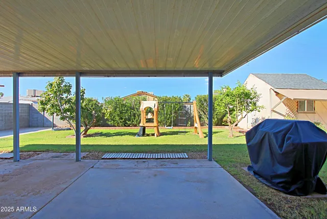 a view of a two chair and table in the patio