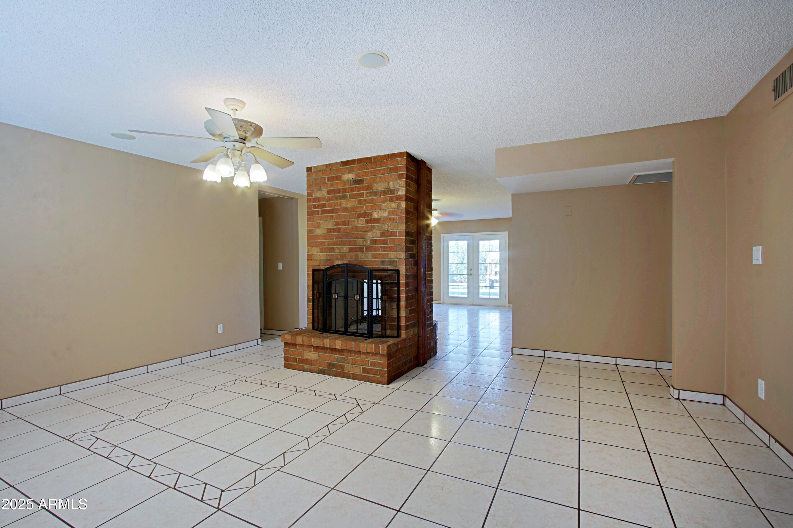 4526 West Altadena Avenue Glendale, AZ 85304 - Photo 3 of 38 a living room with furniture and a fireplace