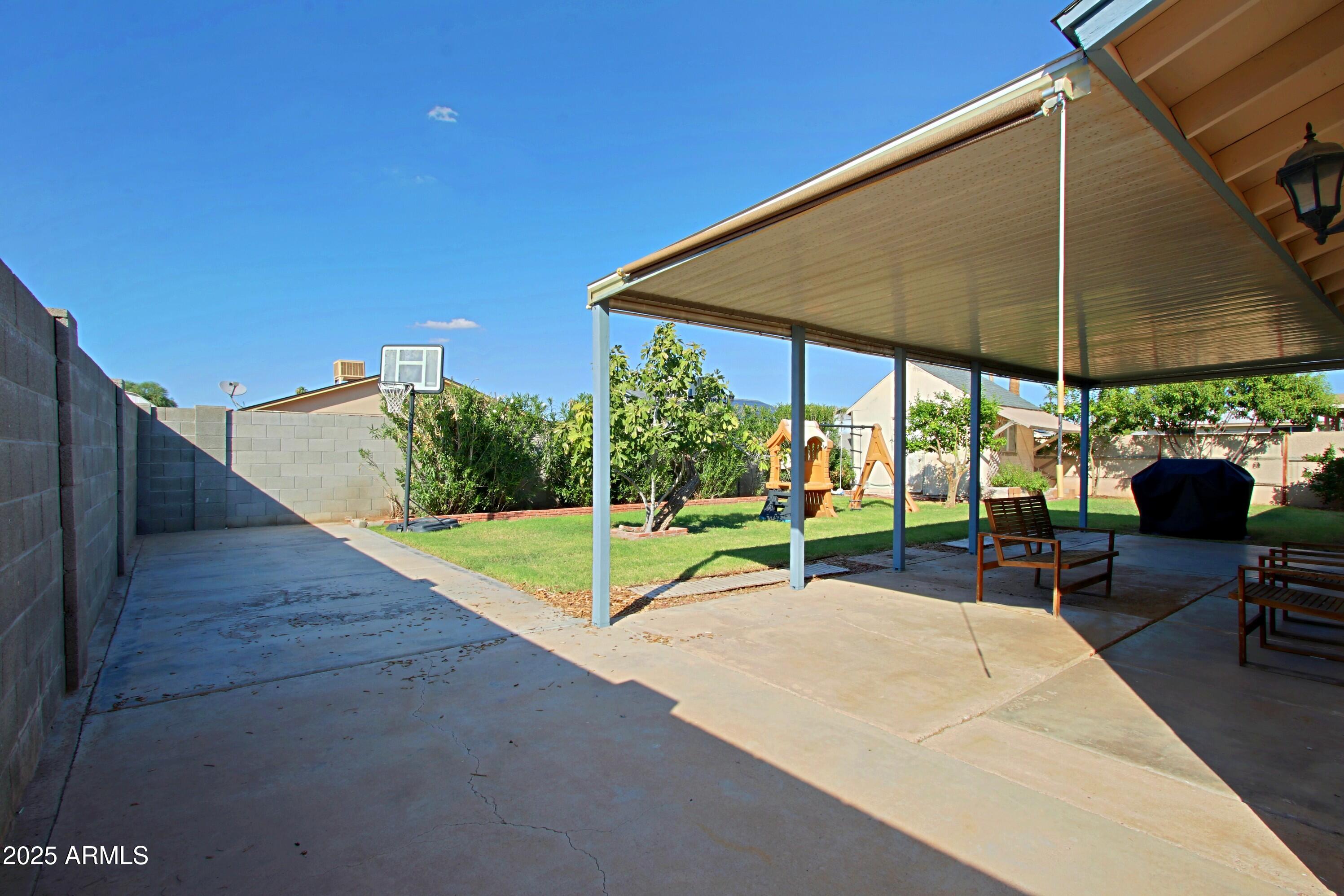 4526 West Altadena Avenue Glendale, AZ 85304 - Photo 32 of 38 a view of a patio with a table and chairs under an umbrella