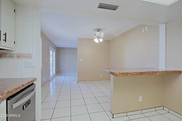 a view of a livingroom with an empty space and a stove top oven