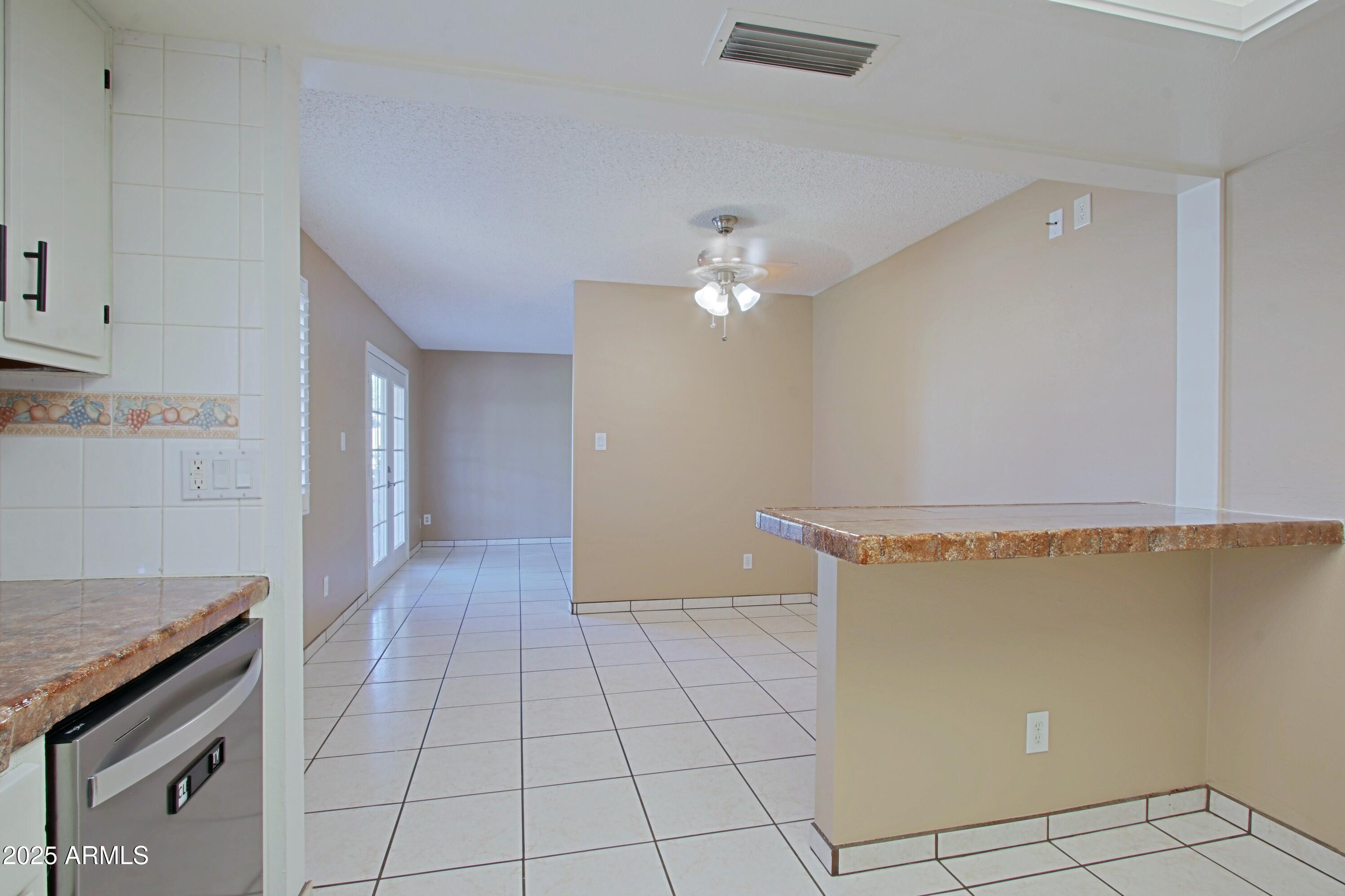 4526 West Altadena Avenue Glendale, AZ 85304 - Photo 10 of 38 a view of a livingroom with an empty space and a stove top oven