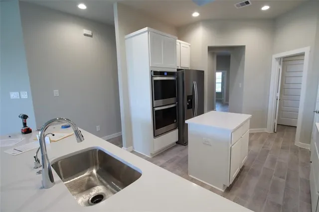 a kitchen with refrigerator and microwave