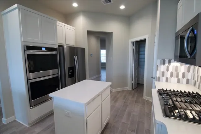 a kitchen with a stove and a refrigerator