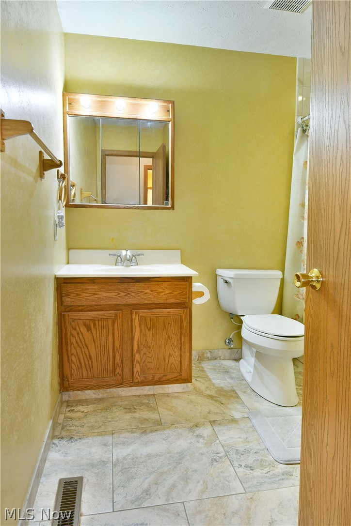 3287 Pheasant Run Road, Unit B Cortland, OH 44410 - Photo 37 of 45 Wood-finish vanity with an integrated sink and mirror