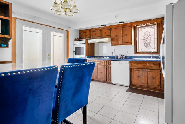a kitchen with stainless steel appliances granite countertop a stove a sink dishwasher and cabinets with wooden floor