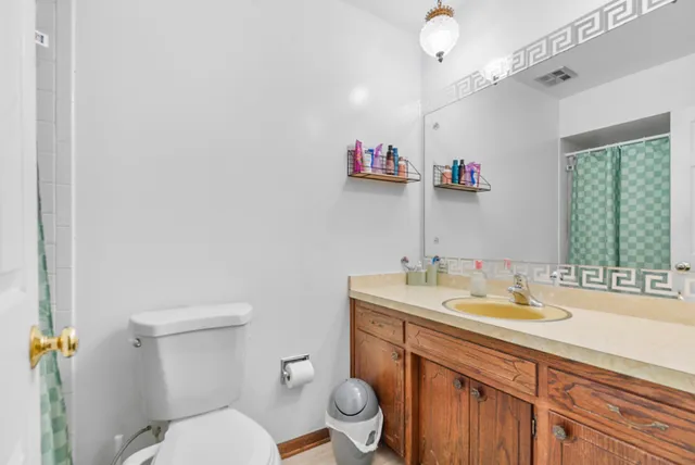 a bathroom with a sink vanity mirror and toilet